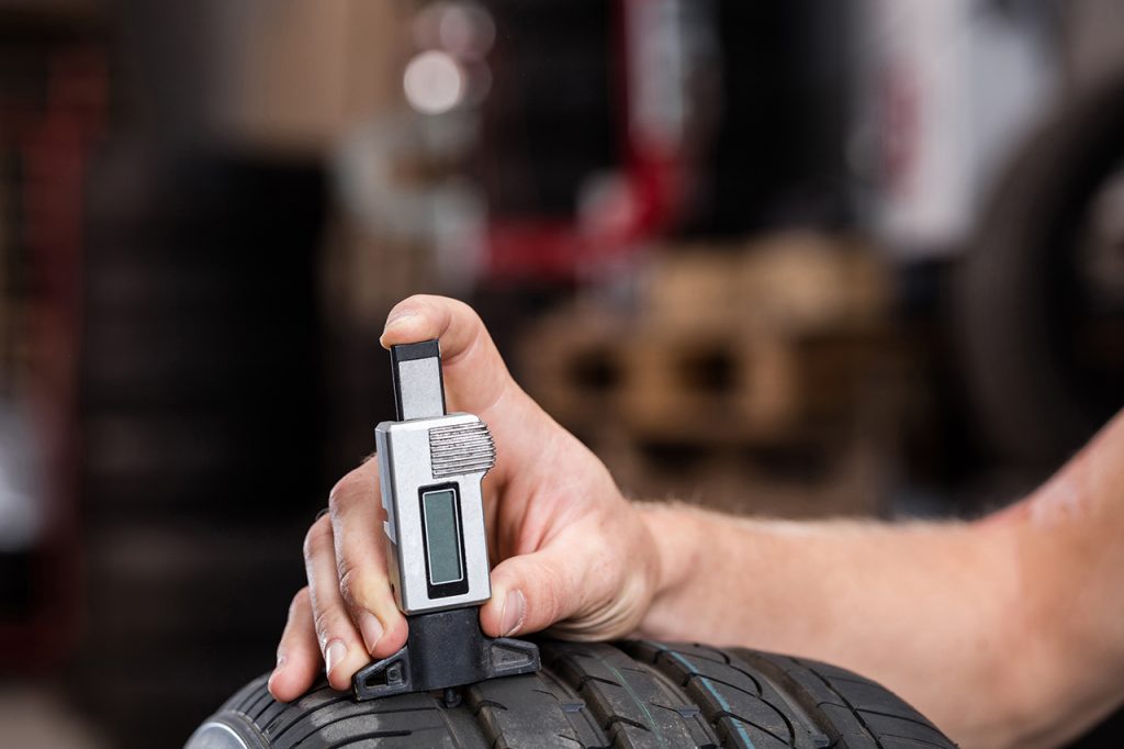 checking tyre tread depth with a digital gauge
